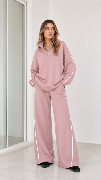 Model wearing dusty pink half zip sweatshirt and wide leg pants loungewear set