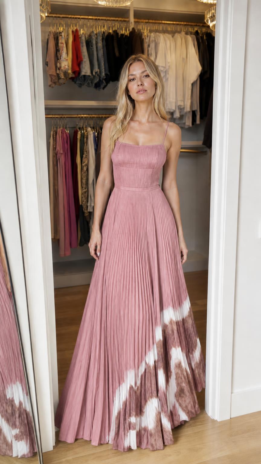 Model wearing pink pleated maxi dress with dip-dye hem