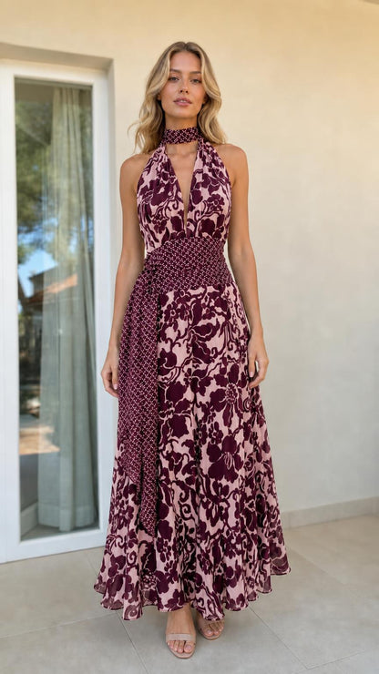 Model wearing rose color variant of halter maxi dress