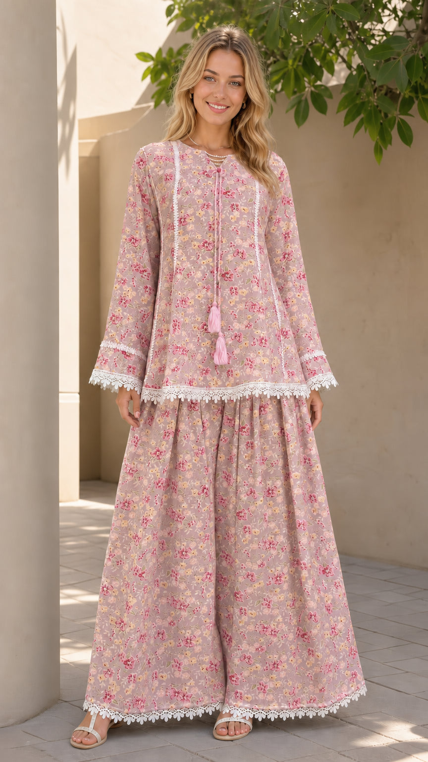 Model wearing pink floral matching tunic and pants set
