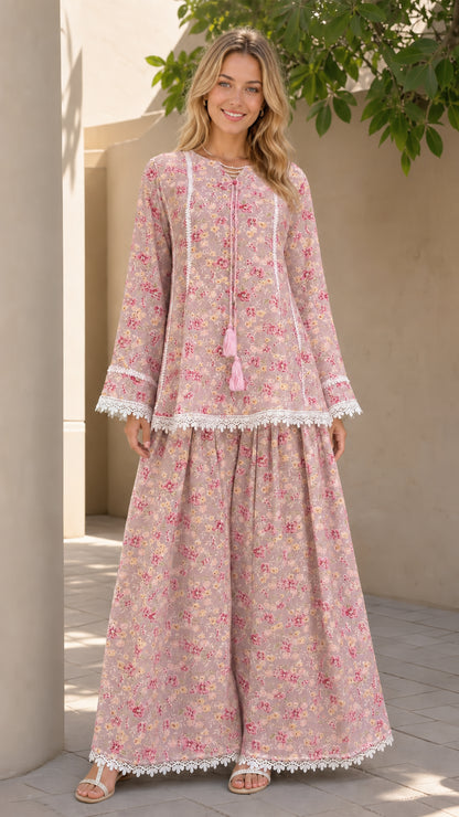 Model wearing pink floral matching tunic and pants set