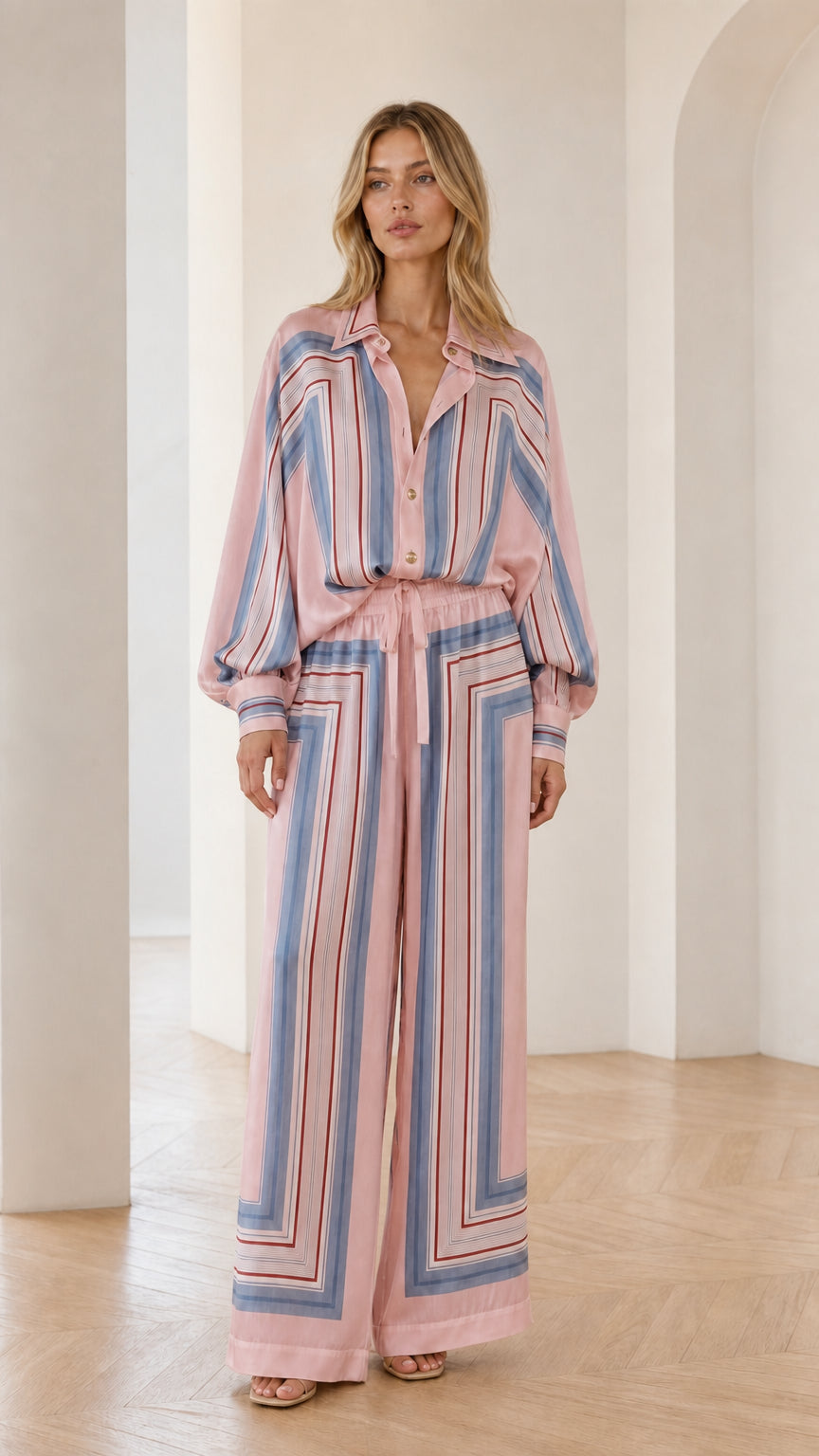 Model wearing pink geometric striped two-piece set