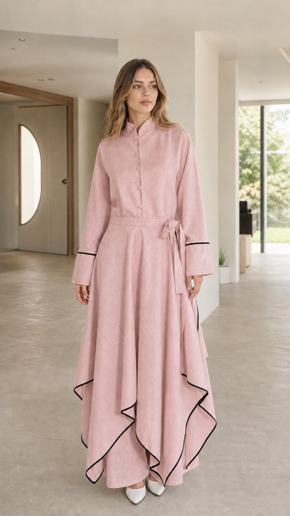 Front view of woman wearing pink maxi dress with contrast trim