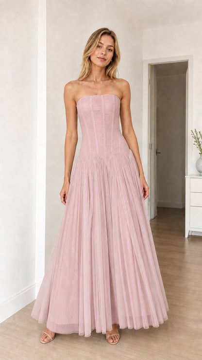 Model wearing blush pink strapless corset tulle maxi dress