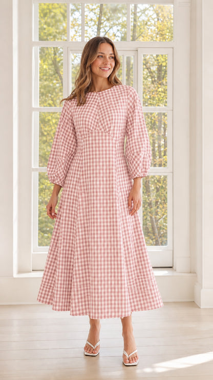 Woman wearing pink gingham midi dress