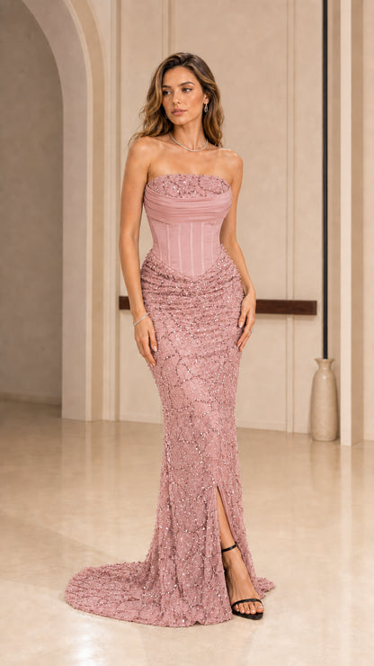 Front view of model wearing dusty rose strapless corset evening dress