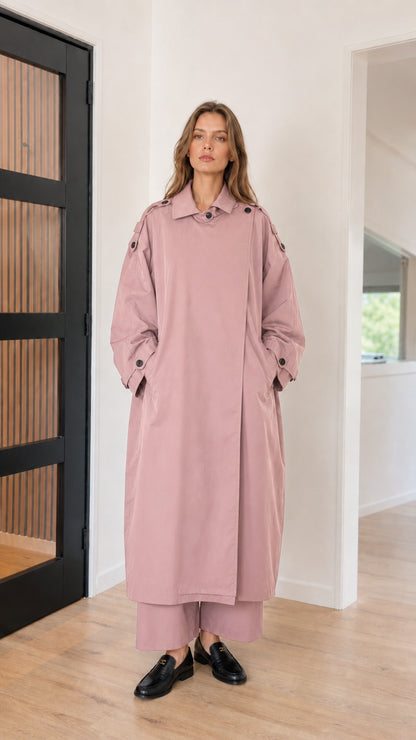 Front full view of woman wearing dusty pink oversized maxi trench coat