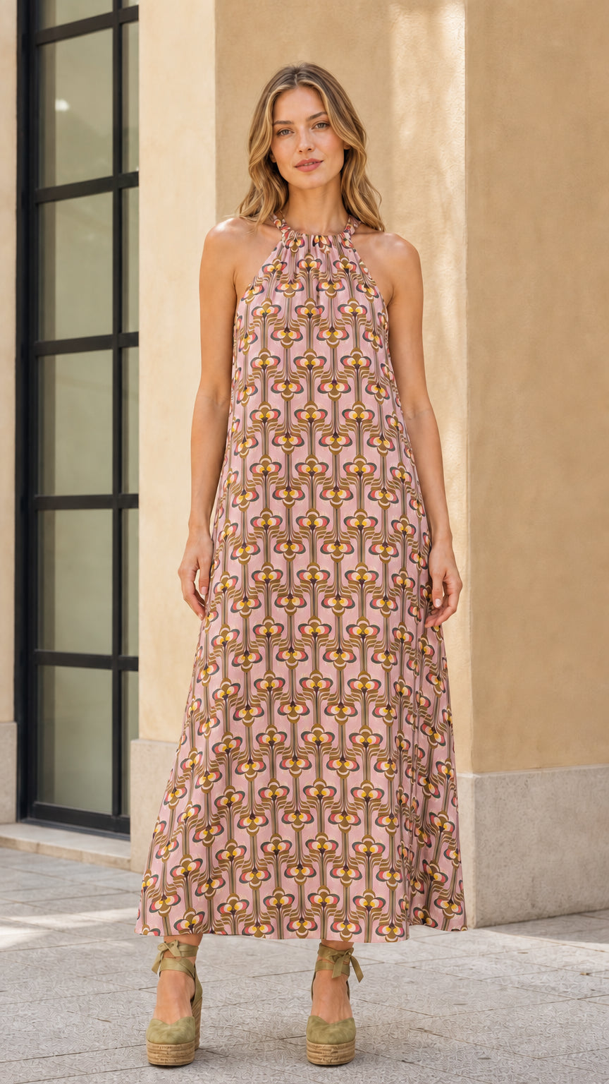 Model wearing pink geo print halter maxi dress