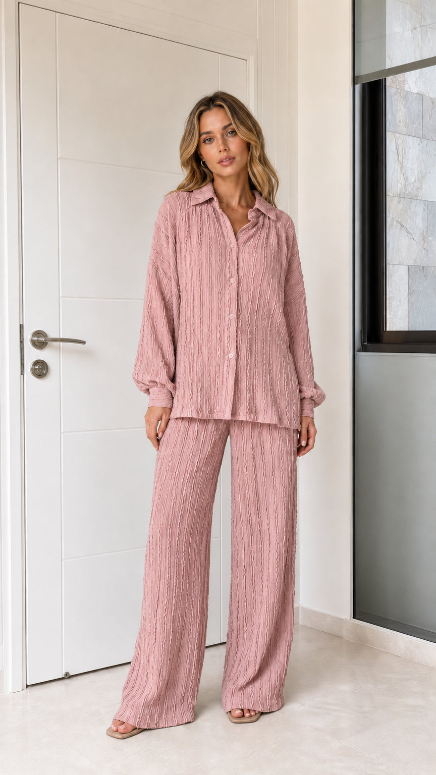 Woman wearing dusty pink textured button-down top and wide-leg pants set