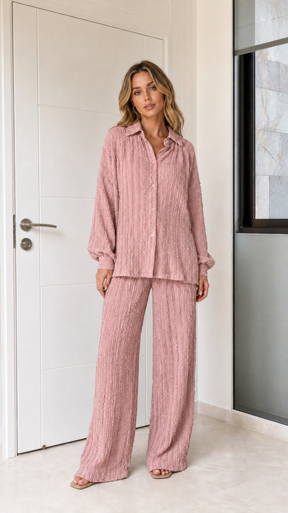 Woman wearing dusty pink textured button-down top and wide-leg pants set