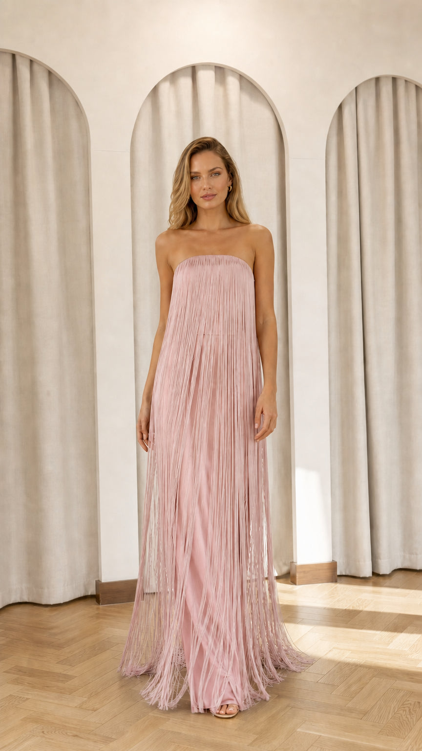Full view of model wearing pink strapless fringe maxi dress