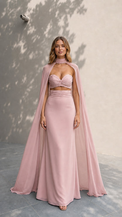 Model wearing dusty rose formal gown with flowing sheer cape