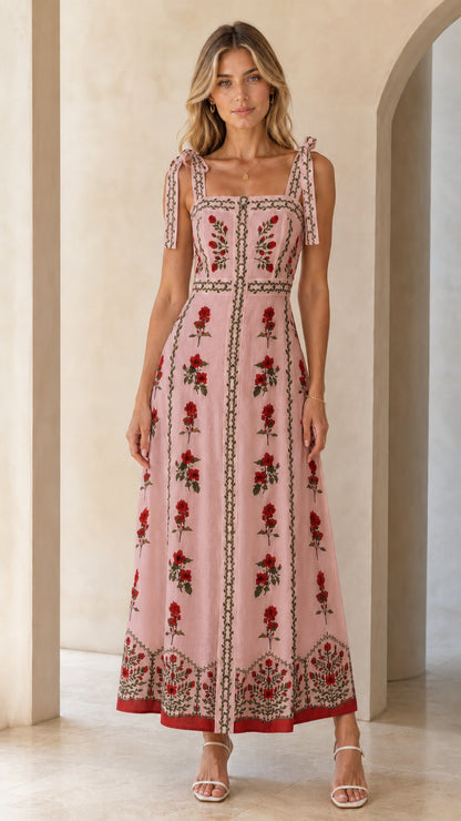Woman wearing pink variant of the floral embroidered maxi dress