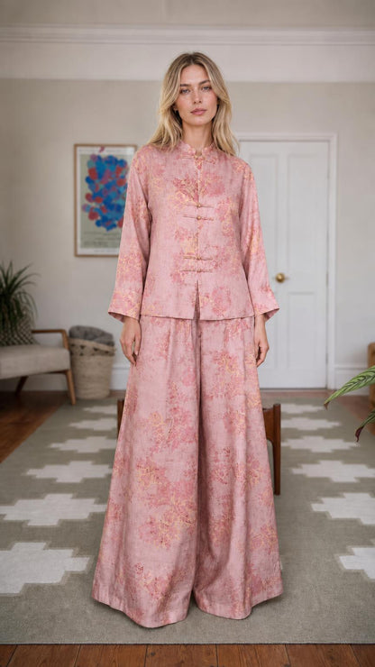 Front view of woman wearing pink floral brocade set