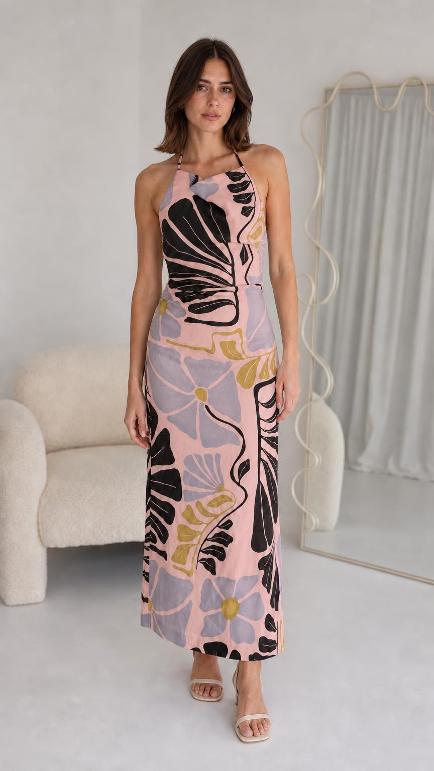 Front view of woman wearing pink floral halter maxi dress