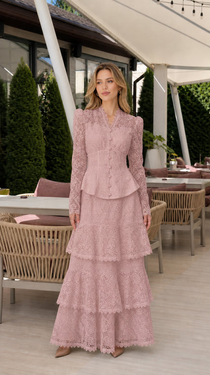 Front full view of woman wearing dusty rose pink long-sleeve lace peplum tiered maxi dress