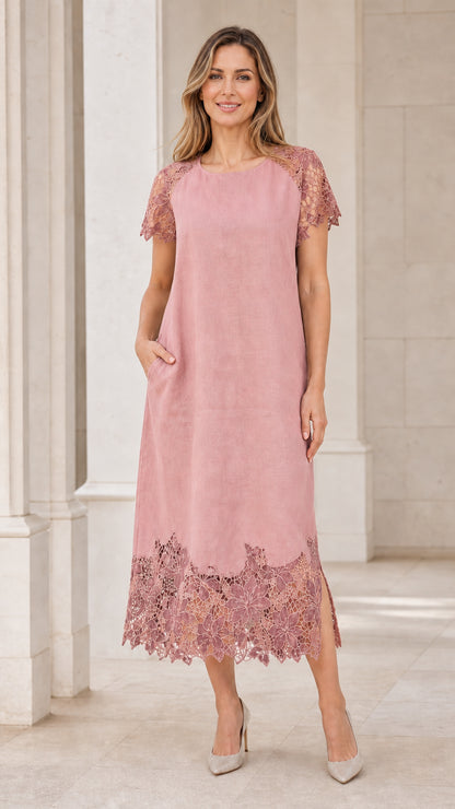 Model wearing soft pink midi dress with lace trim