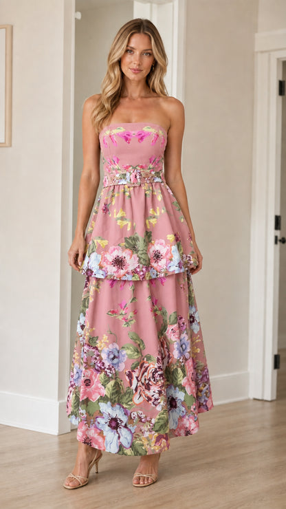 Woman wearing pink floral strapless tiered maxi dress