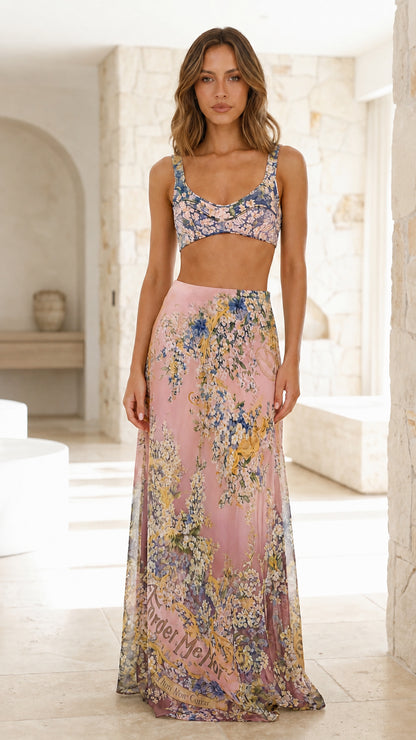 Model wearing pink floral crop top and maxi skirt set