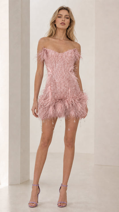 Model wearing pink feather trim sequin mini dress