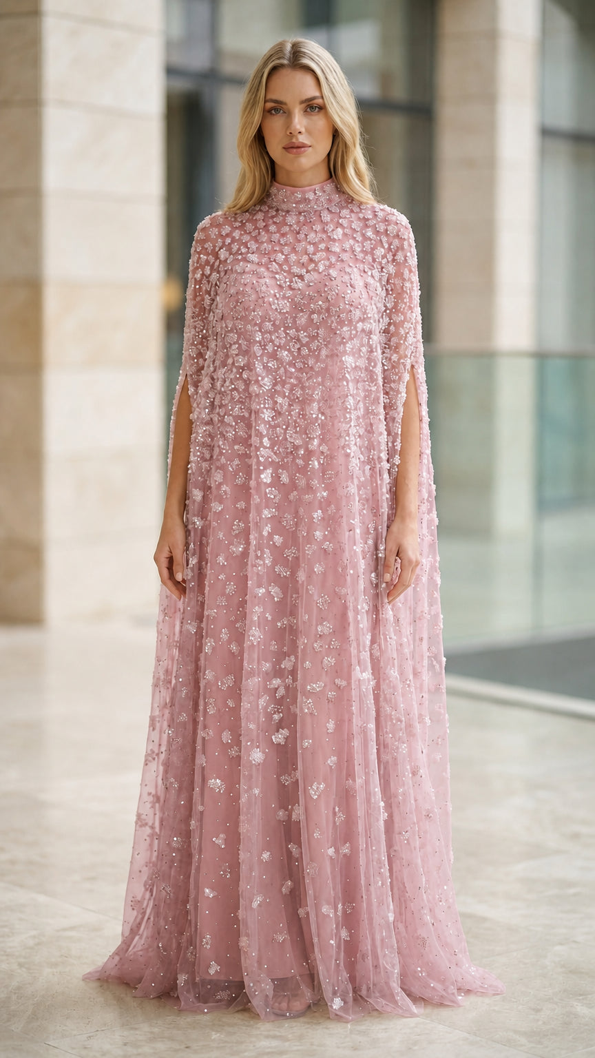 Model wearing dusty rose pink sequined beaded cape evening gown
