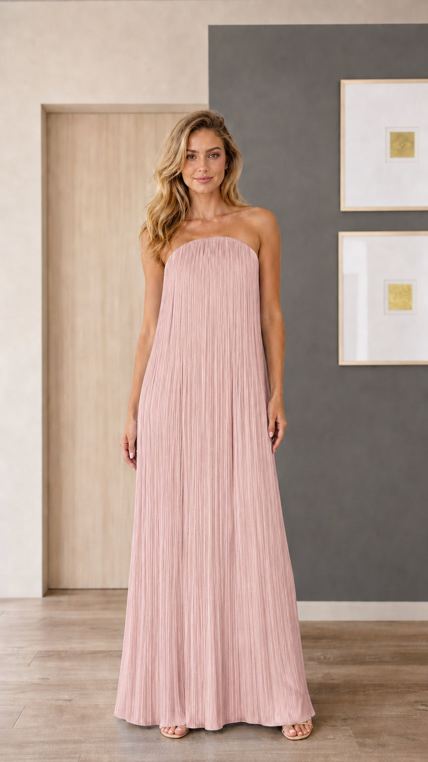 Model wearing dusty pink strapless pleated maxi dress