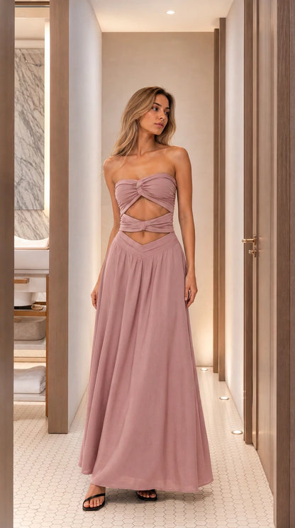 Woman wearing dusty pink cutout strapless maxi dress