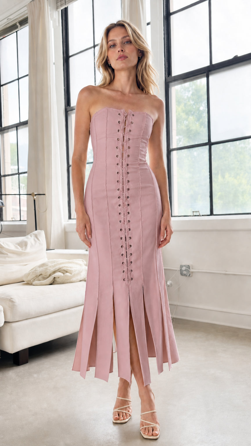 Model wearing pink strapless lace-up midi dress