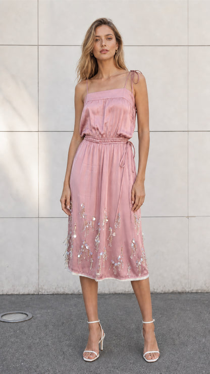 Front view of model wearing pink satin embellished midi slip dress