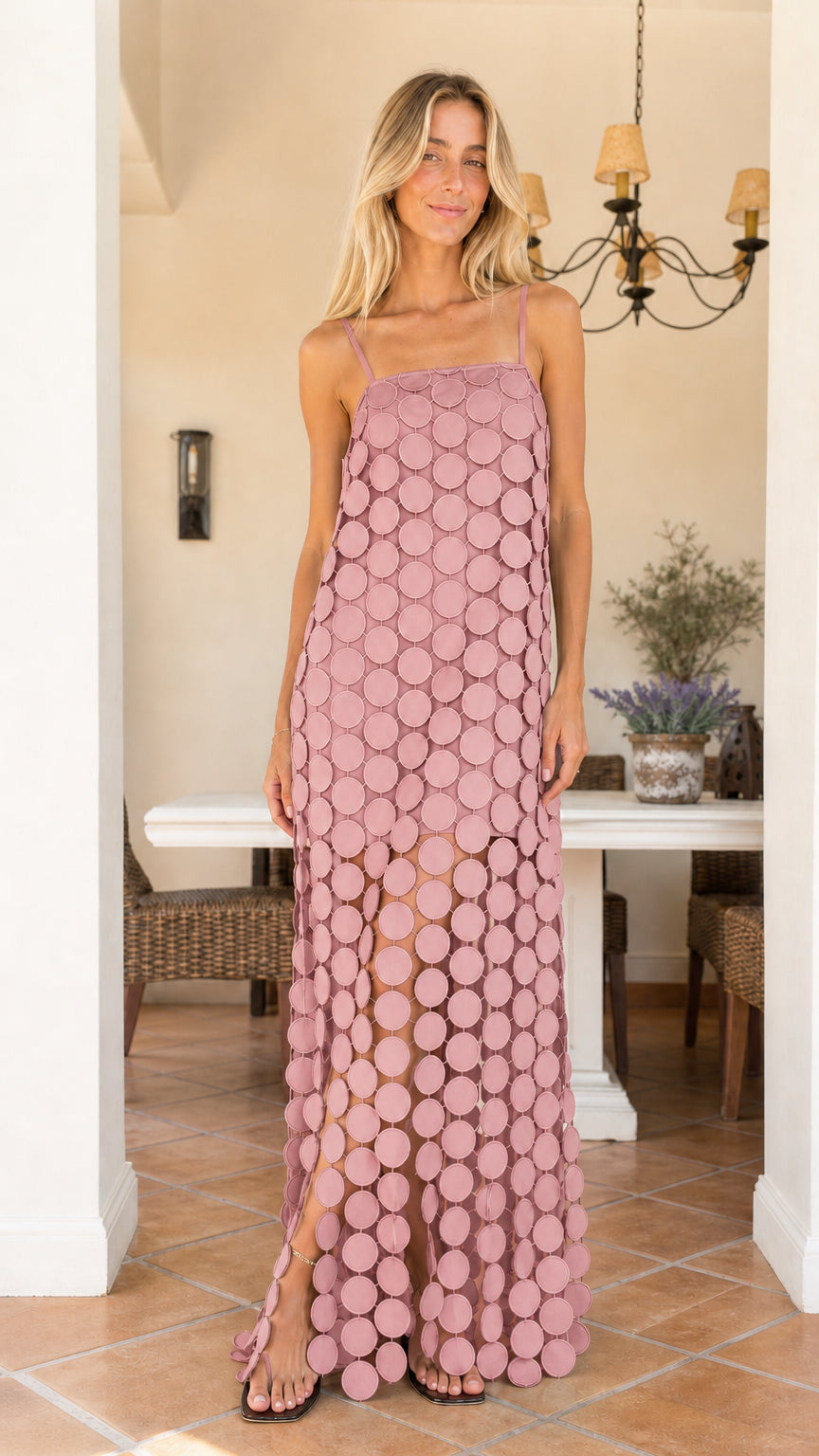 Front view of woman wearing dusty pink cutout circle maxi dress