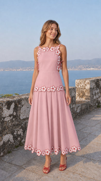Woman wearing soft pink variant of the embroidered floral midi dress