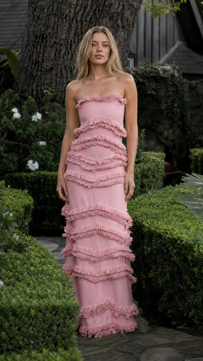 Model wearing pink tiered fringe strapless maxi dress