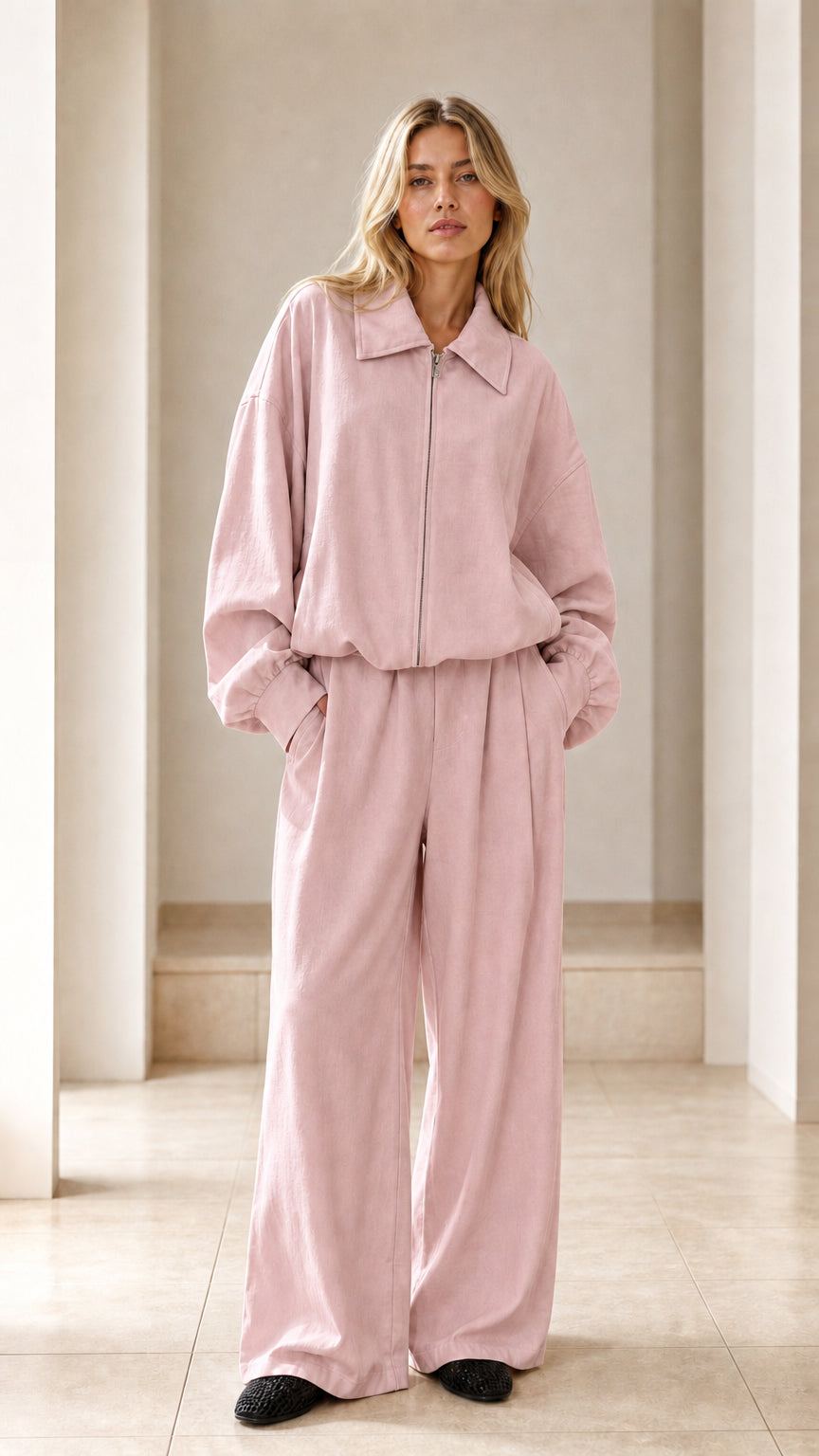 Front view of woman wearing dusty pink zip-up jacket and wide-leg pants set