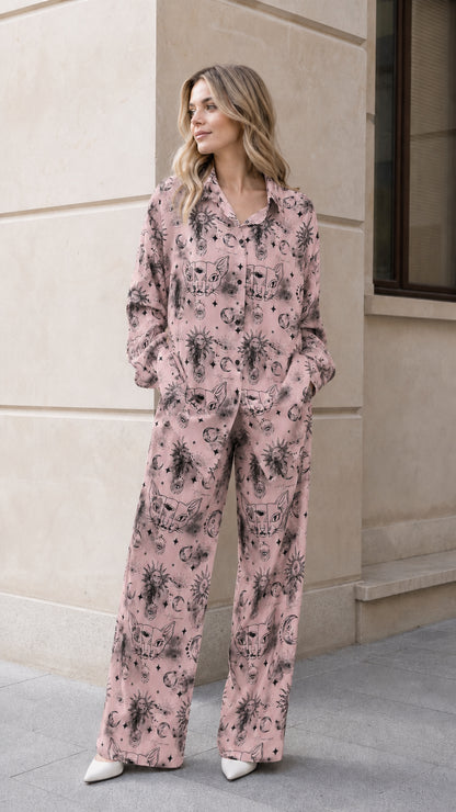 Woman wearing dusty pink celestial print button down pajama set