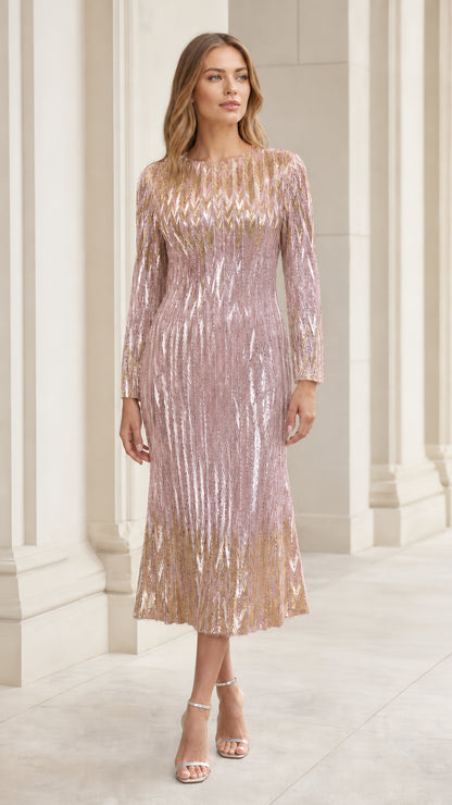 Front view of woman wearing blush pink sequin chevron long sleeve midi dress