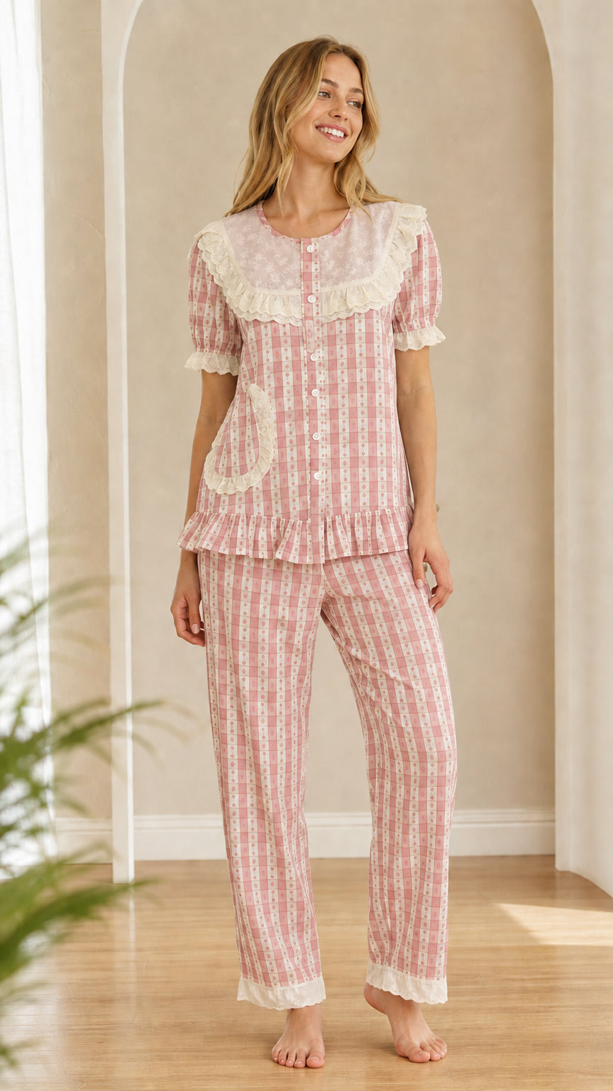Model wearing dusty pink gingham pajama set with ruffled lace collar