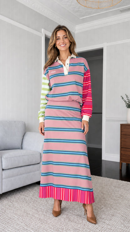 Woman wearing pink colorblock striped polo sweatshirt and maxi skirt set