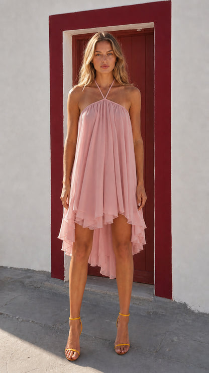 Front view of woman wearing pink halter neck high-low dress