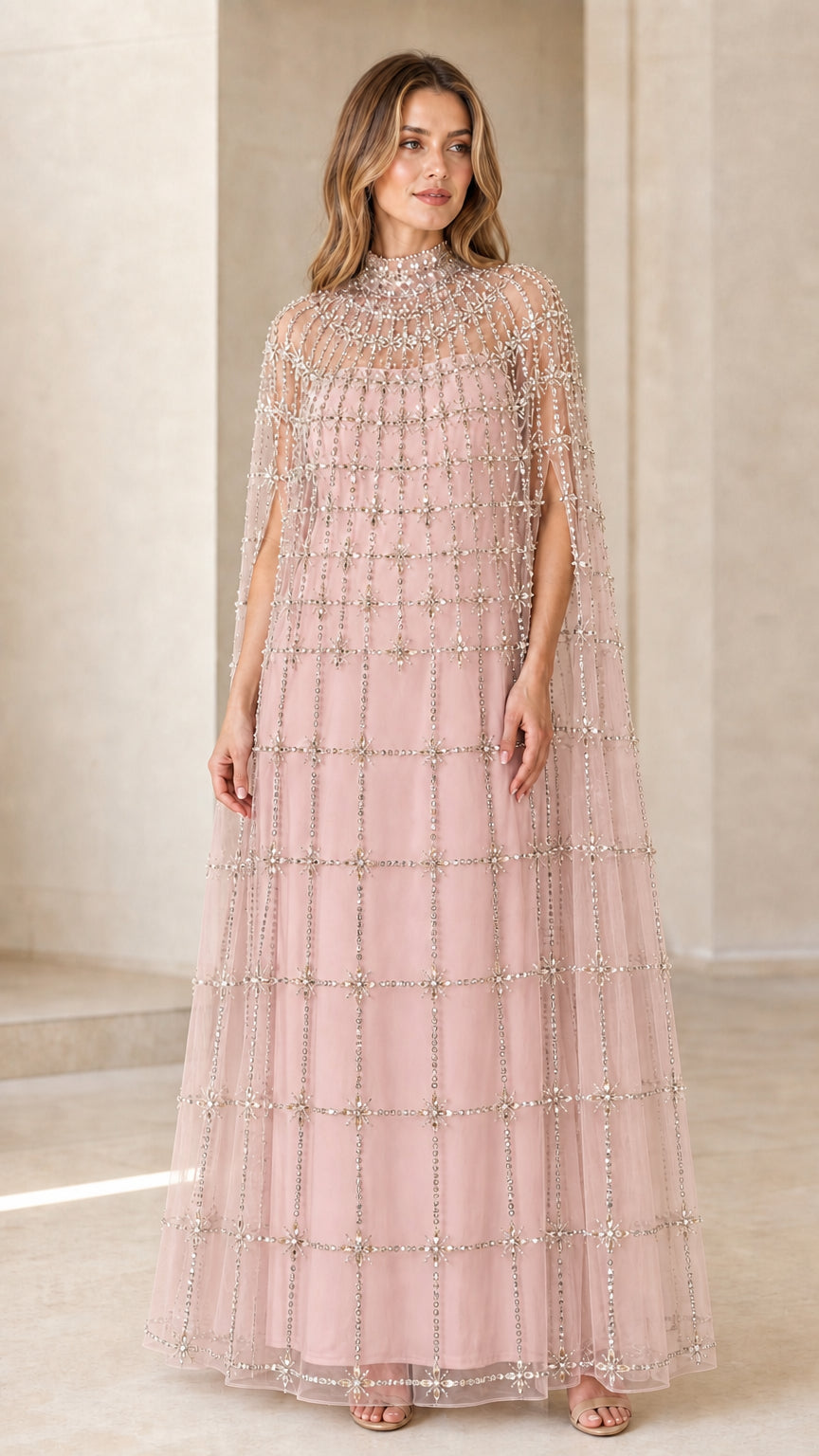 Front view of model wearing Blush Pink crystal beaded cape evening dress