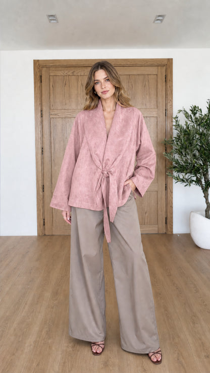 Front view of woman wearing Dusty Pink faux suede tie-front wrap jacket