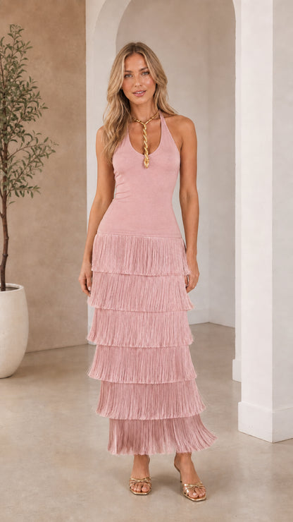 Front view of woman wearing blush pink tiered fringe halter maxi dress