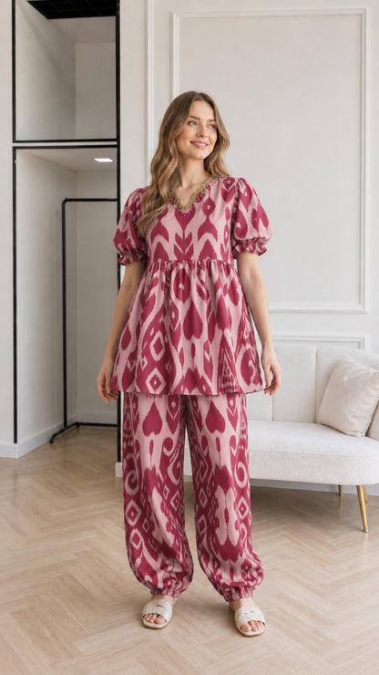 Woman wearing Dusty Rose pink ikat print babydoll top and matching pants set
