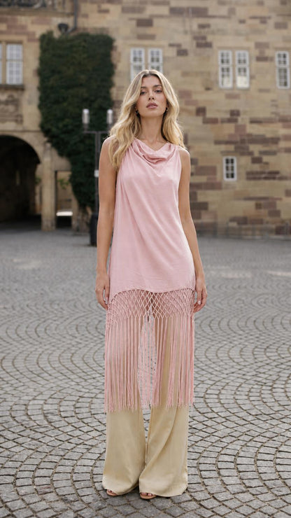 Front view of model wearing pink fringe tunic
