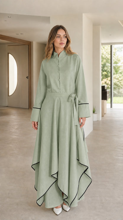 Front view of woman wearing sage green maxi dress with contrast trim