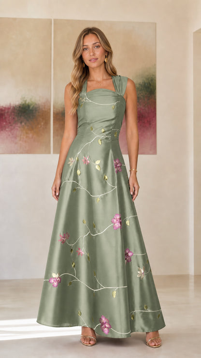 Model wearing sage green embroidered floral evening dress