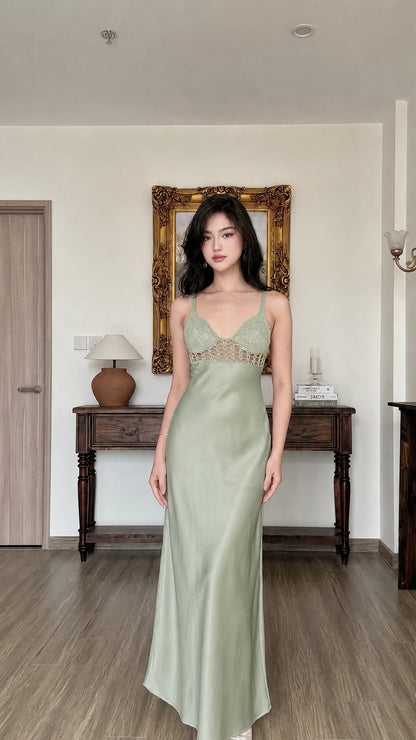 Woman wearing sage green satin maxi slip dress with crochet contrast