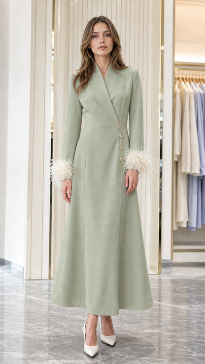 Model wearing Sage Green tailored A-line maxi dress with feather cuffs