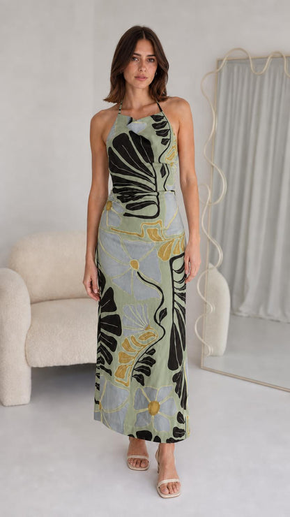 Front view of woman wearing sage floral halter maxi dress