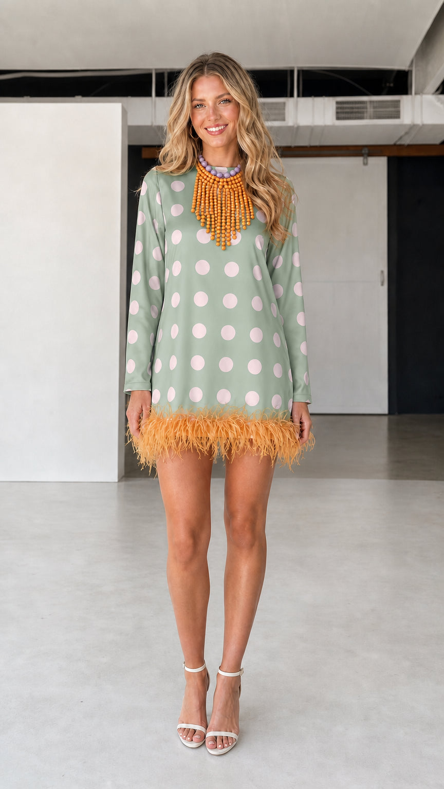 Model wearing green polka dot feather hem dress