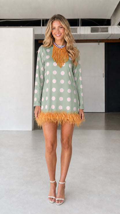 Model wearing green polka dot feather hem dress